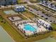 Aerial view of community pool, playground, pickleball courts and surrounding homes at 1011 Swamp Harrier Ave, Ravenel, SC 29470