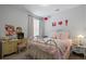 Bedroom with a full-size bed, white bedding, and vintage decor at 1011 Swamp Harrier Ave, Ravenel, SC 29470