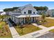 Community clubhouse with farmhouse style and landscaping at 1011 Swamp Harrier Ave, Ravenel, SC 29470