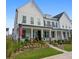 White farmhouse-style home with a porch, brick accents and nicely landscaped garden at 1011 Swamp Harrier Ave, Ravenel, SC 29470