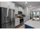 Stainless steel appliances and white cabinets highlight this kitchen at 1011 Swamp Harrier Ave, Ravenel, SC 29470