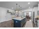 Open concept kitchen with large island and dark blue cabinetry at 1011 Swamp Harrier Ave, Ravenel, SC 29470