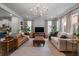 Bright living room featuring two sofas and a large TV at 1011 Swamp Harrier Ave, Ravenel, SC 29470