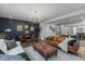 Spacious living room with leather sofas and a large chandelier at 1011 Swamp Harrier Ave, Ravenel, SC 29470