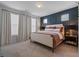 Main bedroom with a king-size bed and dark-blue accent wall at 1011 Swamp Harrier Ave, Ravenel, SC 29470