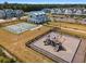 Community playground with modern equipment next to pickleball courts at 1011 Swamp Harrier Ave, Ravenel, SC 29470