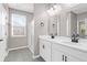 Bathroom boasts double sinks, white cabinets, and a walk-in shower at 1040 Wading Point Blvd, Huger, SC 29450