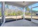 Screened porch with view of wooded area at 1040 Wading Point Blvd, Huger, SC 29450