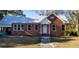 Brick home with metal roof, white door, and landscaped yard at 12240 Green Pond Hwy, Green Pond, SC 29446