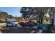 The front yard features a red pickup truck, white minivan, and other vehicles parked on the driveway at 12240 Green Pond Hwy, Green Pond, SC 29446