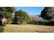 A view of the front yard with a mostly bare lawn and some shrubs and trees in the background at 12240 Green Pond Hwy, Green Pond, SC 29446