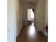 A long hallway with light brown wood flooring, leading to another room at 12240 Green Pond Hwy, Green Pond, SC 29446