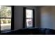 Living room with three windows, dark curtains, and a dark couch at 12240 Green Pond Hwy, Green Pond, SC 29446
