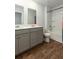 Clean bathroom with double vanity, bathtub, and wood-look floors at 135 Sunray Ln, Summerville, SC 29486