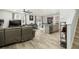 Open concept living room and kitchen with gray sectional sofa and hardwood floors at 135 Sunray Ln, Summerville, SC 29486