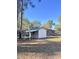 Large backyard with a white shed and green roof at 202 Briarwood St, Walterboro, SC 29488
