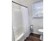 Bathroom with white tub/shower and wood-look flooring at 202 Briarwood St, Walterboro, SC 29488