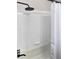 Shower with black fixtures and white subway tile at 202 Briarwood St, Walterboro, SC 29488