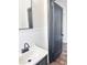 Updated bathroom with white tile, pedestal sink, and dark vanity at 202 Briarwood St, Walterboro, SC 29488