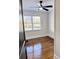 Bright bedroom featuring hardwood floors and ceiling fan at 202 Briarwood St, Walterboro, SC 29488