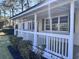 Front porch with white railings and green shutters at 202 Briarwood St, Walterboro, SC 29488