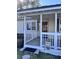 Inviting front porch with white railing and wood floor at 202 Briarwood St, Walterboro, SC 29488