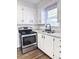 Updated kitchen with white cabinets and new flooring at 202 Briarwood St, Walterboro, SC 29488