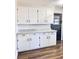 White kitchen cabinets with granite countertops and dark hardware at 202 Briarwood St, Walterboro, SC 29488