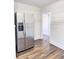 Stainless steel refrigerator in updated kitchen with wood-look flooring at 202 Briarwood St, Walterboro, SC 29488