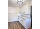 White kitchen cabinets, granite countertops, and wood-look vinyl flooring at 202 Briarwood St, Walterboro, SC 29488