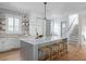 Bright kitchen features white cabinets, center island, and light wood floors at 235 Delahow St, Daniel Island, SC 29492