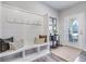 Bright entryway with built-in bench, hooks, and decorative accents at 240 Godwit Dr, Summerville, SC 29486