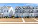 Two-story townhouses with gray and white siding, landscaping, and walkways at 240 Godwit Dr, Summerville, SC 29486