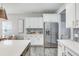 Modern white kitchen with stainless steel refrigerator and ample cabinetry at 240 Godwit Dr, Summerville, SC 29486