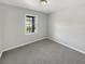 Simple bedroom with grey carpet and large window at 3 Tommy Cir, Goose Creek, SC 29445