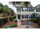 Two-story house with balcony, brick pathway, and landscaped yard with seating area at 3001 Parkwest Boulevard, Mount Pleasant, SC 29466