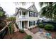 Tan two-story house with a balcony, brick pathway, and a landscaped front yard at 3001 Parkwest Boulevard, Mount Pleasant, SC 29466