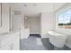 Modern bathroom with dual vanities, soaking tub, glass shower, and hexagonal tile flooring at 351 Wappoo Trace Ln, Summerville, SC 29486