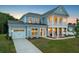 Two-story home with light blue siding, white trim, and a front porch at dusk at 351 Wappoo Trace Ln, Summerville, SC 29486