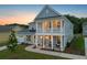 Two-story home with light blue siding, white trim, and a front porch at dusk at 351 Wappoo Trace Ln, Summerville, SC 29486