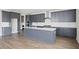 Modern kitchen featuring gray cabinets, a large island, white subway tile backsplash, and stainless steel appliances at 351 Wappoo Trace Ln, Summerville, SC 29486