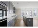 Modern kitchen featuring gray cabinets, quartz countertops, stainless steel appliances, and tile backsplash at 351 Wappoo Trace Ln, Summerville, SC 29486