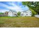 Expansive backyard view, showcasing detached garage and large lawn area at 362 6Th Ave, Mount Pleasant, SC 29464
