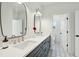 Modern bathroom featuring a double vanity with sleek black cabinets, white countertops, and stylish mirrors and fixtures at 362 6Th Ave, Mount Pleasant, SC 29464