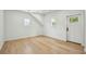 Bedroom with wood floors, two windows and a white door at 362 6Th Ave, Mount Pleasant, SC 29464