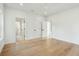 Spacious bedroom with light hardwood floors, white walls, and multiple doorways, offering versatility and a serene atmosphere at 362 6Th Ave, Mount Pleasant, SC 29464