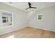 Bedroom with hardwood floors, two windows, and a ceiling fan at 362 6Th Ave, Mount Pleasant, SC 29464