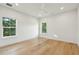 Light-filled bedroom with hardwood floors and a ceiling fan at 362 6Th Ave, Mount Pleasant, SC 29464