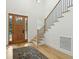 Light-filled entryway with hardwood floors, statement rug and staircase at 362 6Th Ave, Mount Pleasant, SC 29464