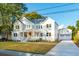 Two story home with white siding, detached garage, and a landscaped lawn at 362 6Th Ave, Mount Pleasant, SC 29464